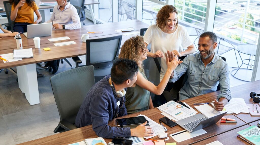People in office giving each other a high five