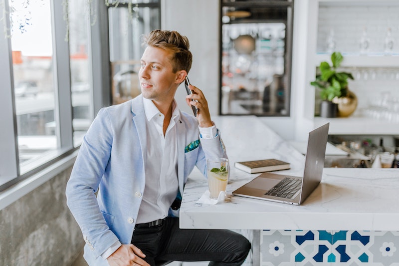 man in suit talking taking a call