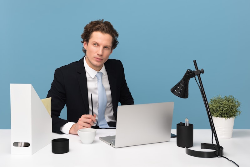 man in suit at desk