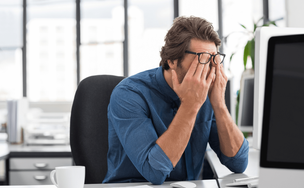 office worker with head in hands