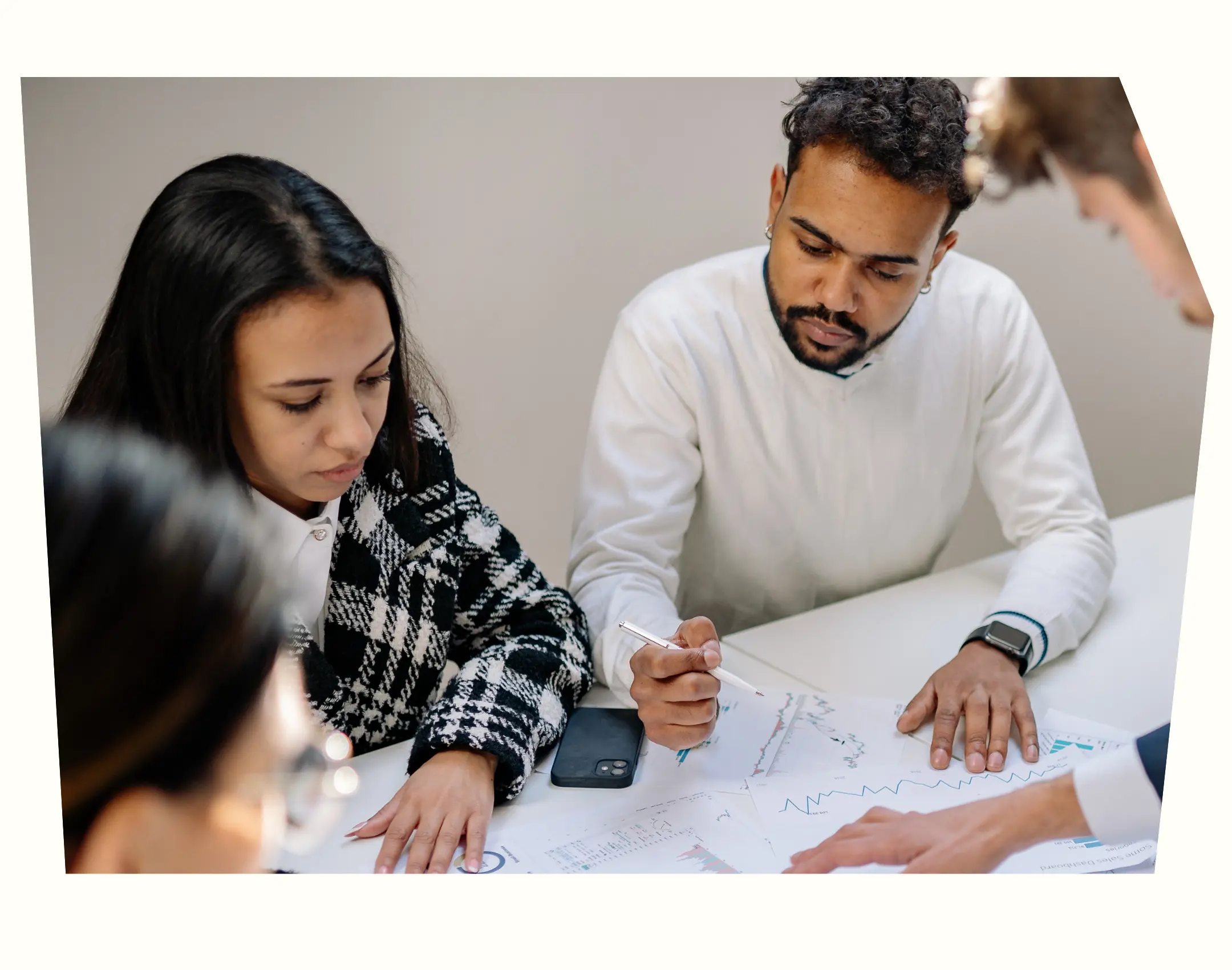 three people looking at data in graph format