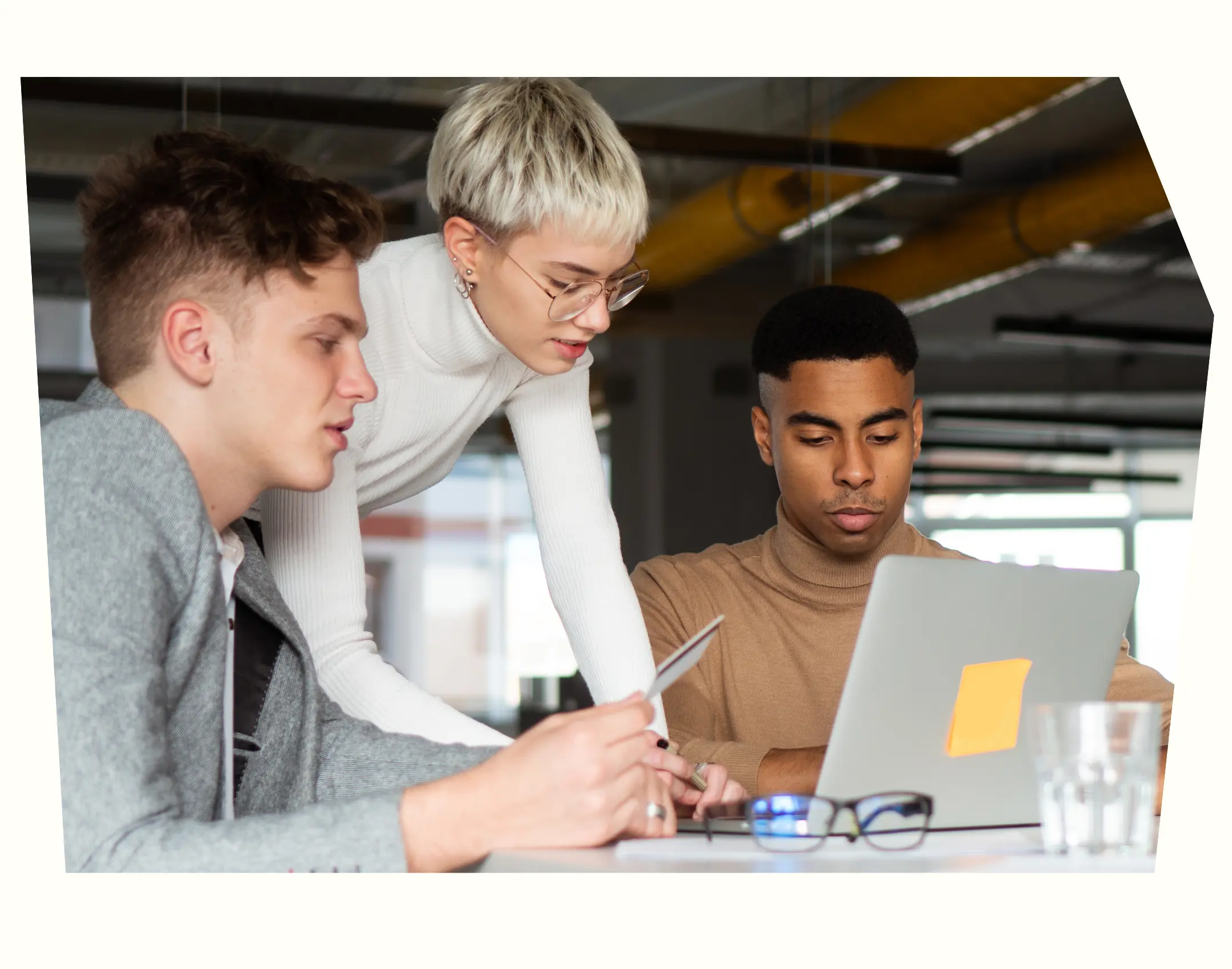 People gathered around a laptop screen
