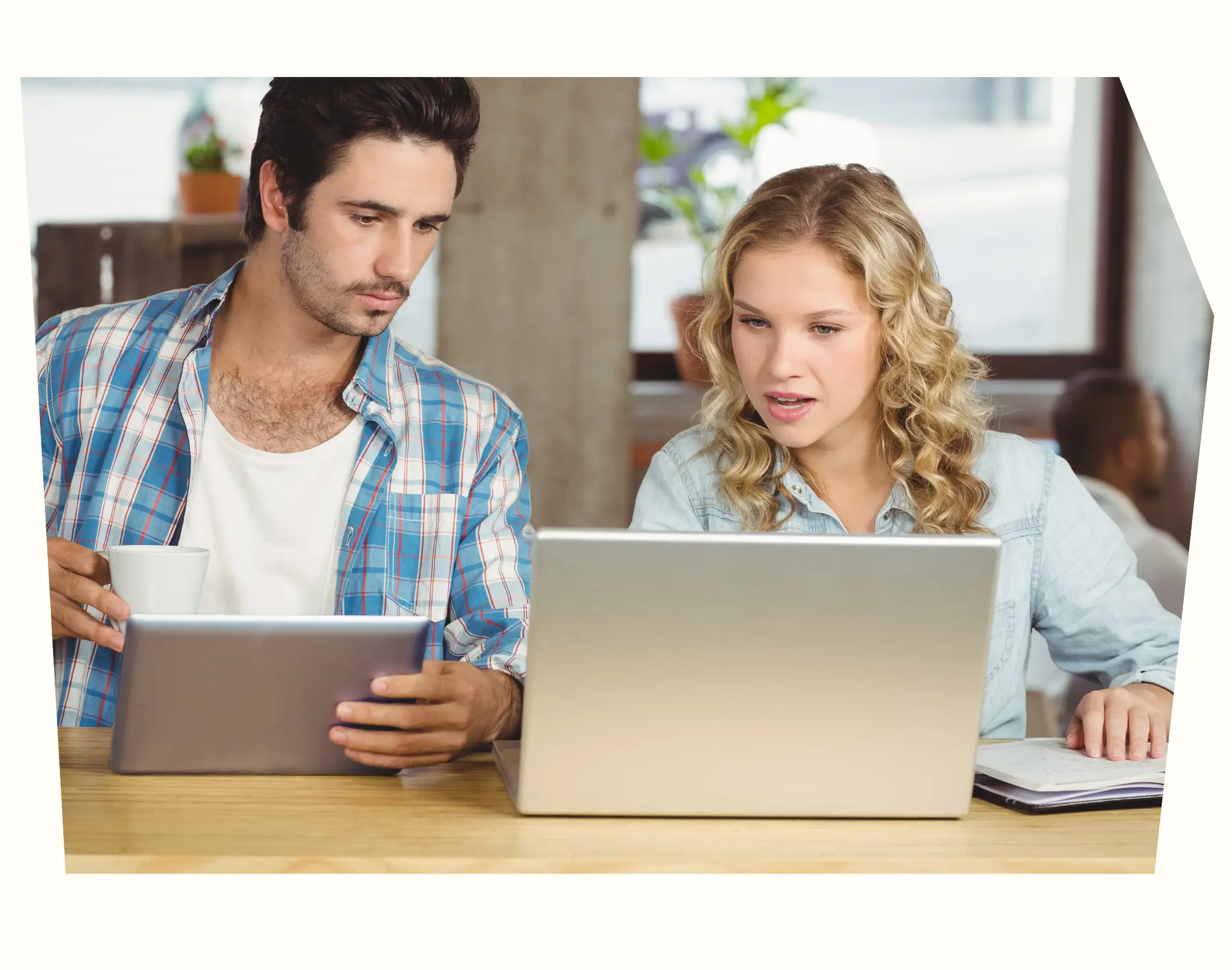 two people preparing for survey launch with laptop and tablet devices